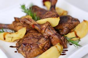 roasted duck leg with mashed potatoes and fresh salad on the plate closeup. horizontal view from abovel photo