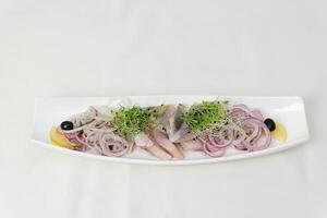 herring Set with delicious salted herring fillets on white background, top view photo