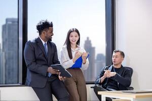 Diversity team of business people are discussing over the new strategic strategy project over investment real estate while working in modern office building for new project and planning photo