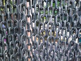 Close-Up of Vertical Iron Chains Hanging in a Row photo