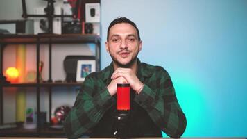 Podcast Host Engaging with Audience in Cozy Studio Using Camera and Broadcast Microphone video