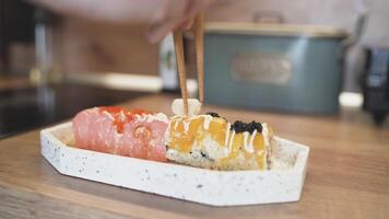 Plating Sushi at Home with Careful Hand Adding Ginger on Top for a Beautiful Homemade Presentation video