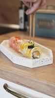 Carefully Adding Pickled Ginger on Homemade Sushi for a Fresh and Elegant Food Presentation at Home video