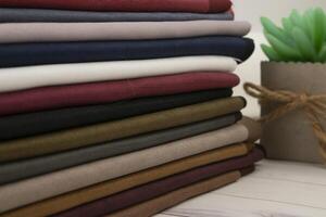 A stack of different colored cloths on a table photo