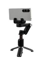 Smartphone mounted in horizontal orientation on compact gimbal stabilizer tripod, isolated on white back photo
