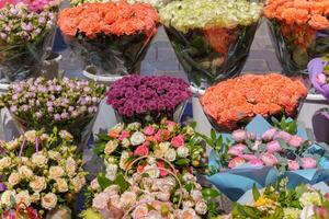 Many bouquets of different flowers are for sale. Natural decorative background. photo