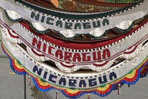 A clock with a bunch of different colored knitted banners photo