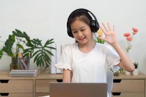 Back to School online learning with girl waving during call photo