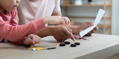 Activity of father and son exploring creative projects in a home setting photo