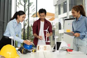 Innovative Engineering Team. Engineers collaborating on sustainable design with wind energy solutions. photo
