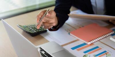 Business Collaboration and Financial Planning. A professional discussing strategies with a calculator. photo