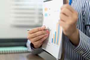 Business Analysis and Reporting. Professional reviewing data charts in a modern office. photo