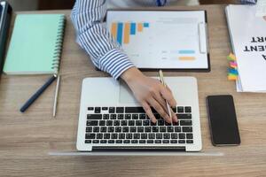 Remote Work and Digital Transformation. Close-up of professional woman using laptop for data analysis. photo