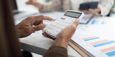 Detailed Financial Analysis. Close-up of hands using a calculator for budget calculations. photo