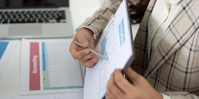 Financial Reporting and Analysis. Business professional reviewing charts and data on clipboard. photo