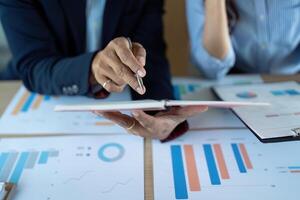 Business Collaboration and Financial Analysis. Professionals discussing data insights in a modern office. photo