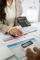 Engaging Financial Discussion. Accountant presenting summary report and calculator to client. photo