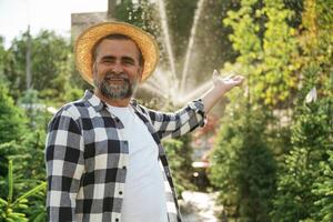 Automatic watering system behind. Senior gardener is at work at daytime photo