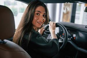 Conception of test drive. Beautiful businesswoman is in the,, new car photo