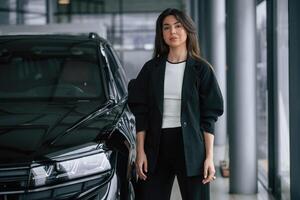 Saleswoman in ,car ,showroom, selling automobile photo
