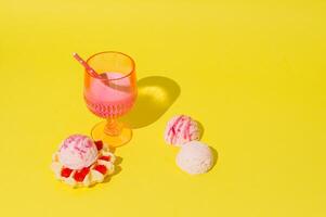 Summer scene with pink tropical refreshing drink waffle with raspberries and ice cream scoops on yellow background. Sun and shadows. Minimal cocktail concept. Trendy party idea. Summer aesthetic. photo