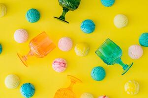 Colorful pattern with ice cream scoops and vibrant cocktail glasses on bright yellow background. Food and drink concept. Trendy party idea. Fun, festive and playful layout. Flat lay style. Top view. photo