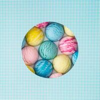 Creative summer composition with colorful ice cream scoops visible through a circle shaped gap on white and blue background. Sweet food concept. Trendy yummy dessert idea. Flat lay style. Top view. photo