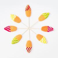 Vibrant and playful summer layout made of ice cream shaped lollipops on white background. Creative candy concept. Colorful sweet food background. photo