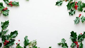 Festive holly leaves and bright red berries arranged on a clean white background to celebrate the holiday season photo