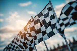 Vibrant checkered racing flags waving against a bright sky, perfect for motorsport events and high-speed racing themes during daylight photo