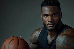 Athletic black man with tattoos holding a basketball, showcasing skill and confidence in a training session photo