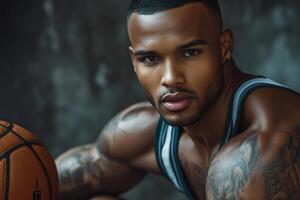 Handsome basketball player with athletic build holds ball, showcasing tattooed arms and low haircut against textured backdrop photo