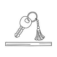 A tassel dangling from a keychain in key on a wooden desk vector