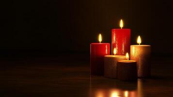 Warm golden and red candles arranged gracefully on a dark background creating a festive glow photo