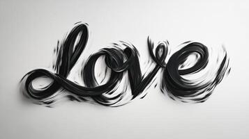 Elegant black cursive text spelling love with a flowing underline on a white background creating a romantic and artistic expression of affection photo