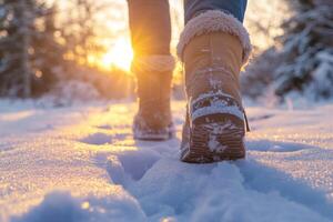 Walking through fresh snow at sunset, wearing cozy boots, enjoying the tranquility of a winter evening photo