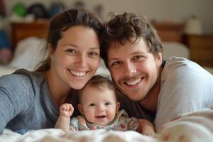 A joyful family sharing smiles together in bed during a cozy morning at home with their baby photo