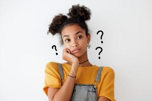A young woman in a thoughtful pose with her hand on her chin and question marks, reflecting curiosity and contemplation in a bright setting photo