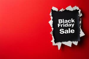 Announcing the Black Friday sale with a torn paper effect on a vibrant red background for an exciting shopping experience photo