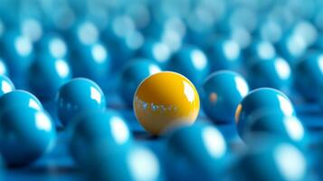 Yellow sphere stands out among blue spheres creating a visually striking pattern in a creative setting photo