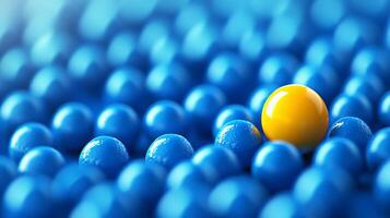 Yellow ball standing out among blue balls on a smooth surface in a visually striking abstract composition photo