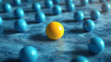 Bright yellow sphere stands out among scattered blue spheres on a textured surface in an artistic arrangement photo