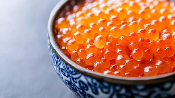 Fresh fish roe in a decorative bowl ready for culinary use during a seafood preparation session in a cozy kitchen photo