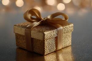 A golden gift box with a ribbon and a bow photo