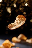 A piece of potato chips is floating in the air photo