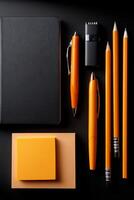 A black notebook, pencils, pens, and a notepad photo