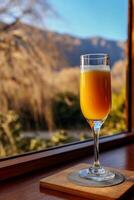A glass of orange juice sitting on a table photo