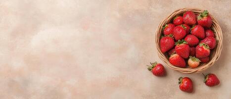 Ripe Red Strawberries Filling Wicker Basket. Scattered Berries Beside Container on Light Brown Textured Surface. Garden Harvest of Fresh Fruit. photo