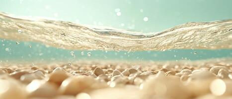 Clear water surface over smooth stones. Bubbles float near the blue background. Underwater view of a light sandy ground with wave. photo