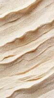 Close up of sand. Golden sand surface. Diagonal wavy line pattern. Grainy texture of sand. Arid background. Beige nature backdrop. photo